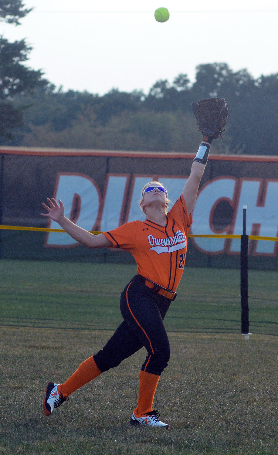 Bailee Dare (below) goes back to make a catch in right field with the Dutchgirls signage in the background during Owensville’s 21-2 victory over St. James in the nightcap of last Wednesday’s FRC doubleheader at OHS Field.